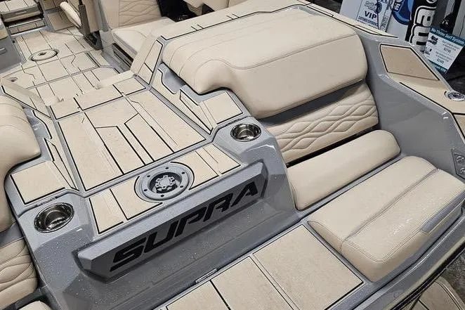 Slide: The Image of 2026 Supra SL boat interior with beige seating and sleek design. - 11