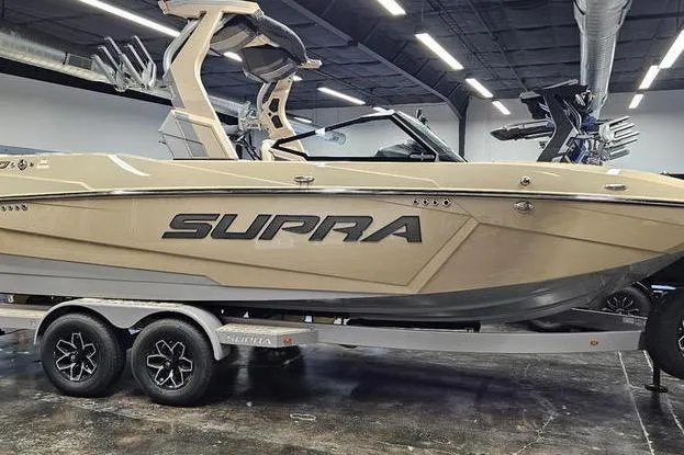 Slide: The Image of 2026 Supra SL boat on trailer in showroom, sleek design, modern features. - 4