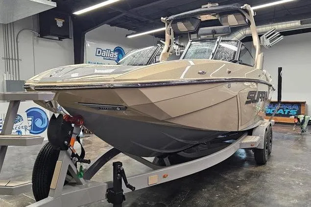 Slide: The Image of 2026 Supra SL boat on trailer in showroom, featuring sleek design and modern features. - 5