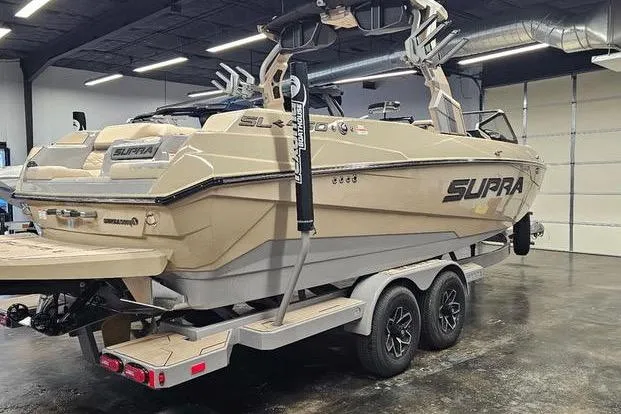 Slide: The Image of 2026 Supra SL boat on trailer in indoor showroom setting. - 8