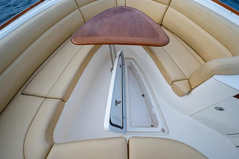 Slide: The Image of 2018 Hunt Yachts 32 Center Console interior with beige seating and wooden table. - 14