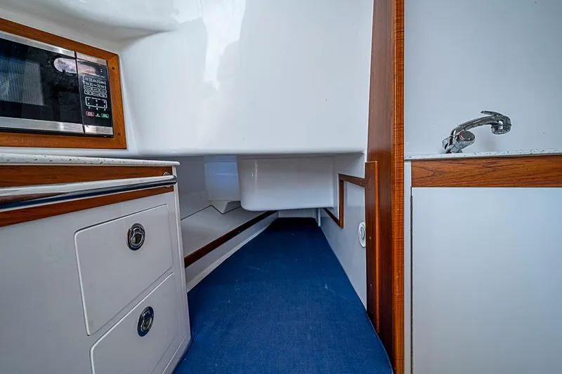 Slide: The Image of 2018 Hunt Yachts 32 Center Console interior with microwave, sink, and storage. - 16