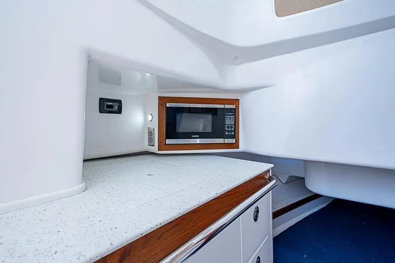 Slide: The Image of 2018 Hunt Yachts 32 Center Console interior with microwave and sleek countertop. - 17