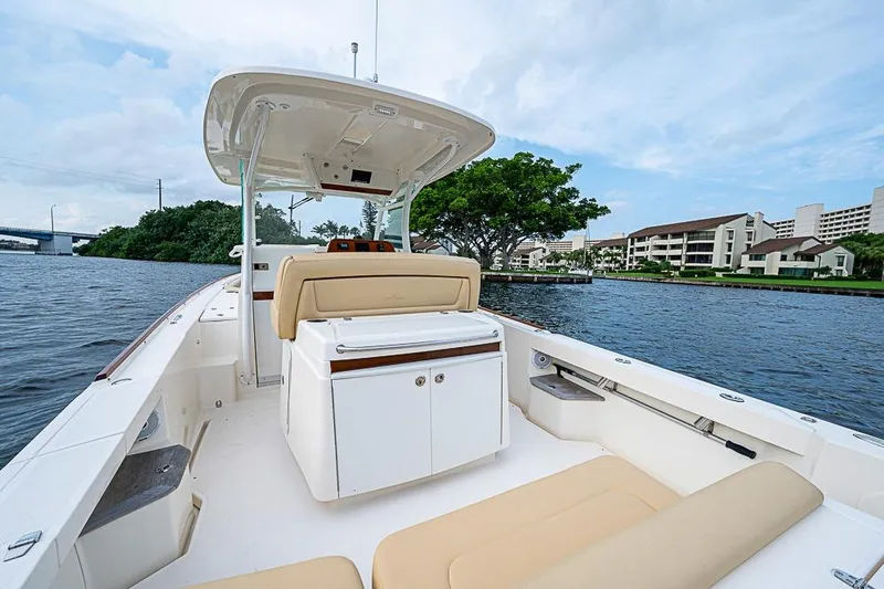 Slide: The Image of 2018 Hunt Yachts 32 Center Console on calm water, featuring spacious seating and sleek design. - 6
