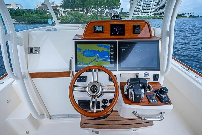 Slide: The Image of 2018 Hunt Yachts 32 Center Console helm with navigation screens and controls. - 8