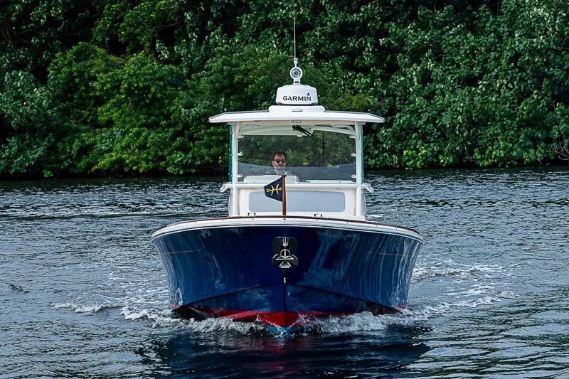 Slide: The Image of 2018 Hunt Yachts 32 Center Console cruising on a scenic waterway. - 2