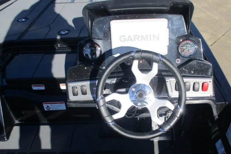 Slide: The Image of 2026 Nitro Z19 XL Pro boat dashboard with Garmin display and steering wheel. - 5