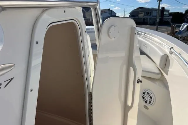 Slide: The Image of 2020 Cobia 237 Center Console boat interior with open door and seating area. - 7