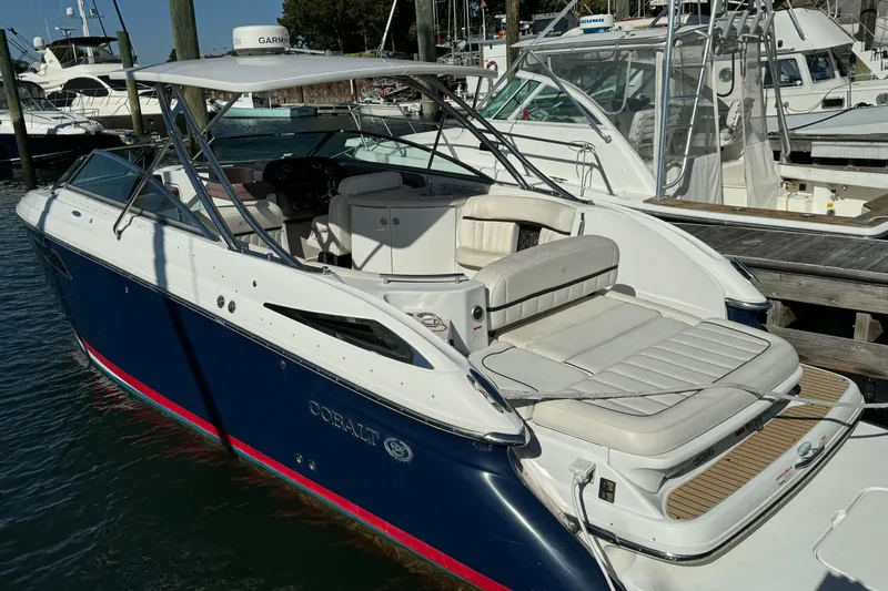 Slide: The Image of 2013 Cobalt 336 boat docked, featuring sleek design and spacious seating. - 0
