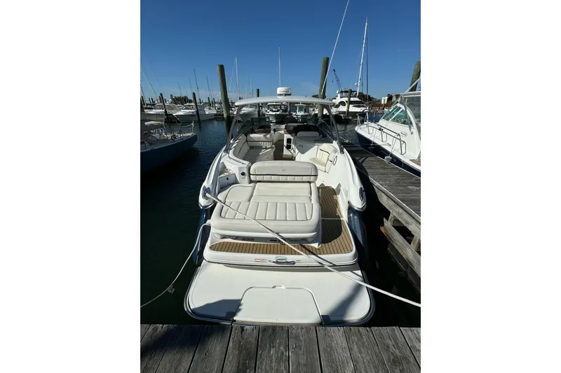 Slide: The Image of 2013 Cobalt 336 boat docked at marina, featuring spacious seating and sleek design. - 1