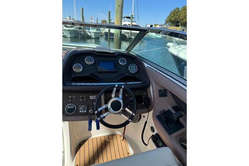 Slide: The Image of Interior view of 2013 Cobalt 336 boat cockpit with steering wheel and dashboard controls. - 10