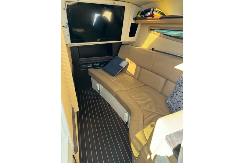 Slide: The Image of 2013 Cobalt 336 cabin interior with leather seating, TV, and striped flooring. - 11