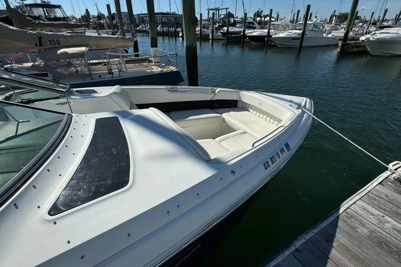 Slide: The Image of 2013 Cobalt 336 boat docked at marina, featuring sleek design and spacious seating. - 3