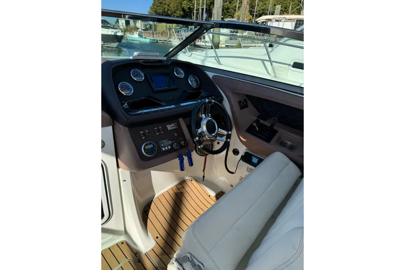 Slide: The Image of Interior view of 2013 Cobalt 336 boat cockpit with steering wheel and dashboard controls. - 9