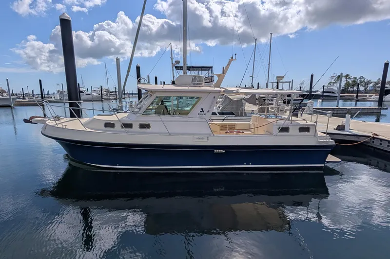 The Image of 2004 Albin 30 Family Cruiser docked at marina under blue sky. - 0