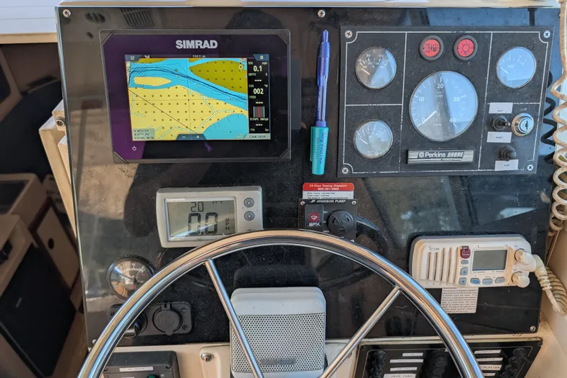 Slide: The Image of Control panel of a 2004 Albin 30 Family Cruiser with navigation and engine gauges. - 14