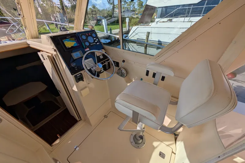 Slide: The Image of 2004 Albin 30 Family Cruiser helm with steering wheel and navigation controls. - 17