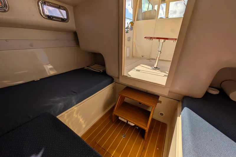 Slide: The Image of Interior of 2004 Albin 30 Family Cruiser with cozy seating and wooden flooring. - 28