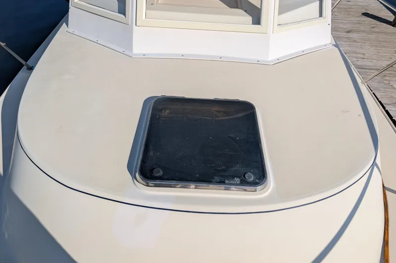 Slide: The Image of 2004 Albin 30 Family Cruiser deck with hatch, docked at marina. - 32