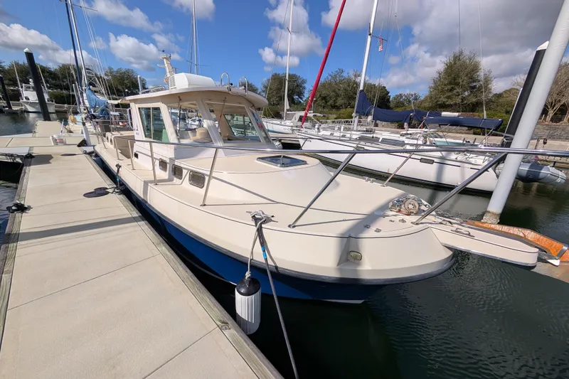 Slide: The Image of 2004 Albin 30 Family Cruiser docked at marina under blue sky. - 38