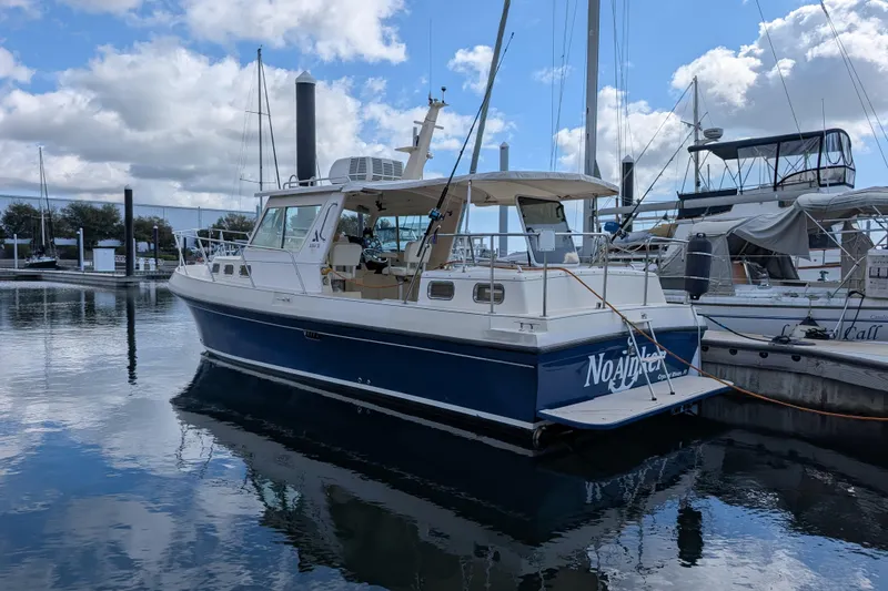 Slide: The Image of 2004 Albin 30 Family Cruiser docked at marina under cloudy sky. - 40