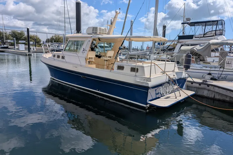 Slide: The Image of 2004 Albin 30 Family Cruiser docked at marina under partly cloudy sky. - 41