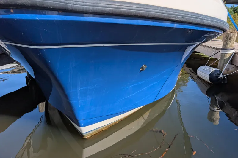 Slide: The Image of Blue hull of 2004 Albin 30 Family Cruiser docked in calm water. - 43
