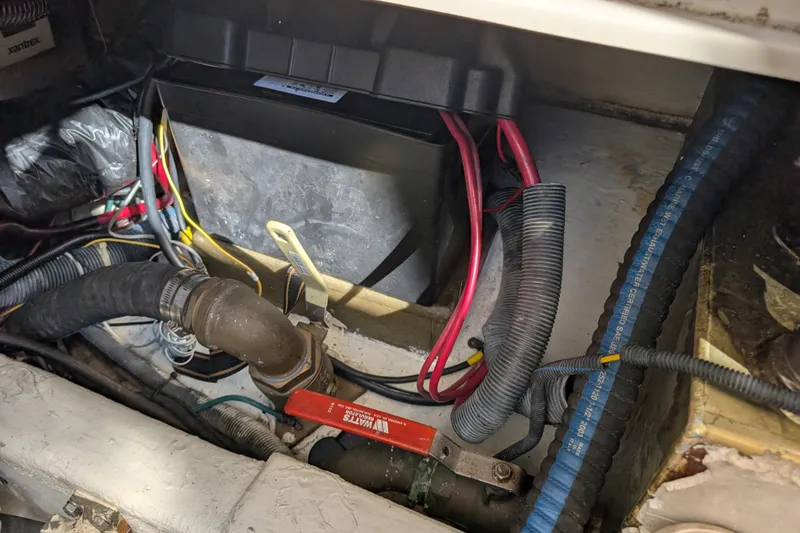 Slide: The Image of 2004 Albin 30 Family Cruiser engine compartment with battery and wiring. - 53