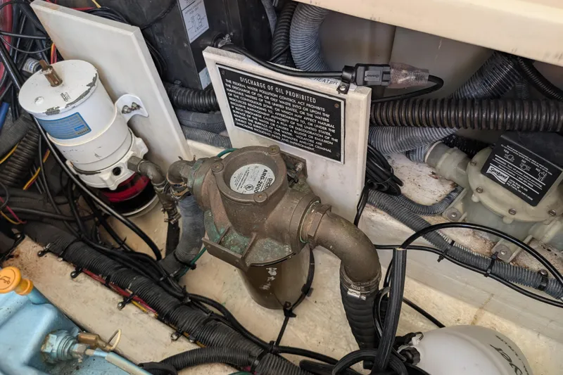 Slide: The Image of Engine compartment of 2004 Albin 30 Family Cruiser with various mechanical components. - 55