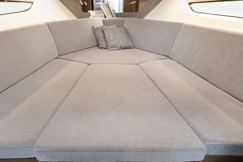 Slide: The Image of Interior view of 2026 Beneteau Flyer 10 Sport Top, featuring a spacious, cushioned seating area. - 11