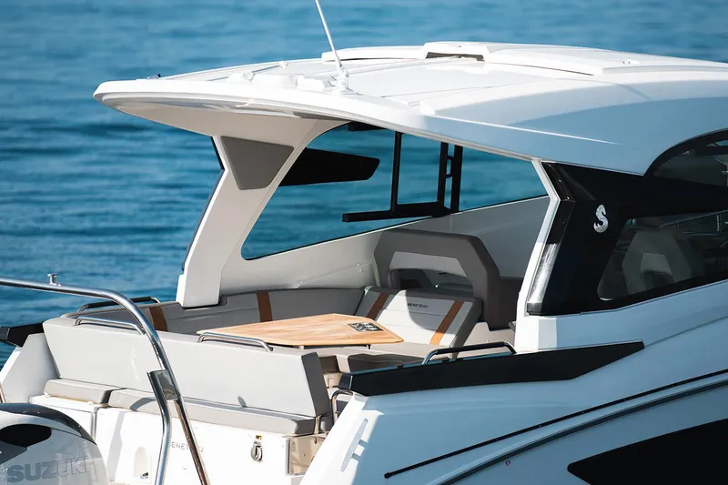 Slide: The Image of Manufacturer Provided Image: 2026 Beneteau Flyer 10 Sport Top boat with sleek design on calm water. - 2