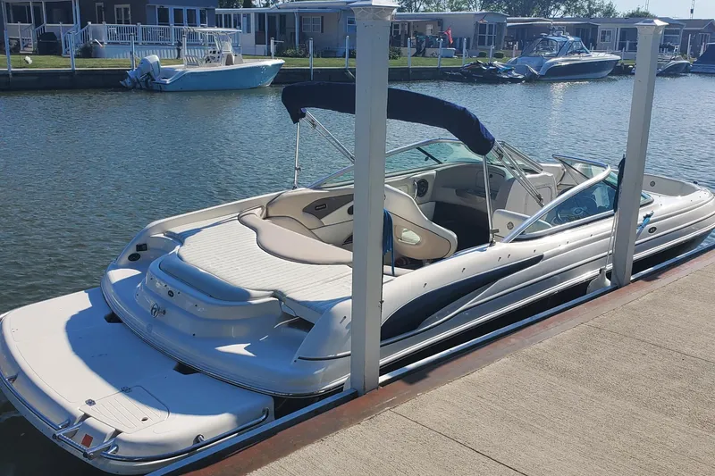 Slide: The Image of 2007 Bryant 219 boat docked at a marina, featuring sleek design and comfortable seating. - 2