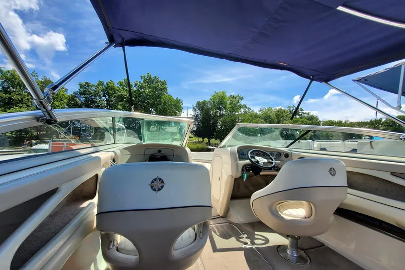 Slide: The Image of Interior of a 2007 Bryant 219 boat with canopy, steering wheel, and seating. - 5