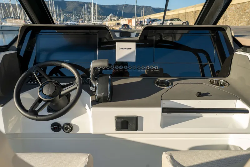 Slide: The Image of 2026 Wellcraft 28 T-Top boat dashboard with steering wheel and modern controls. - 10