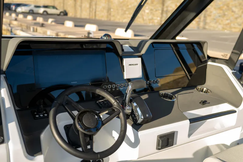 Slide: The Image of Helm of 2026 Wellcraft 28 T-Top boat with modern controls and displays. - 11