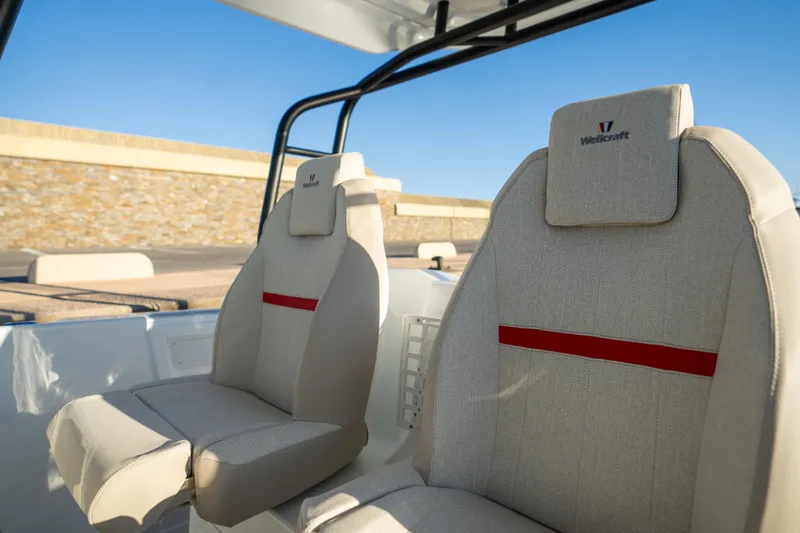 Slide: The Image of 2026 Wellcraft 28 T-Top boat seats with beige upholstery and red accents. - 12