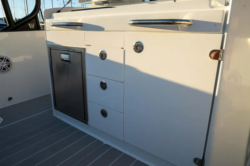 Slide: The Image of Interior view of 2026 Wellcraft 28 T-Top boat with sleek cabinetry and stainless steel accents. - 13