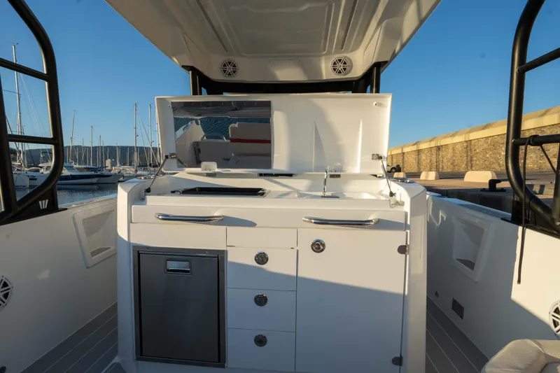 Slide: The Image of 2026 Wellcraft 28 T-Top boat interior with sleek cabinetry and modern design. - 16