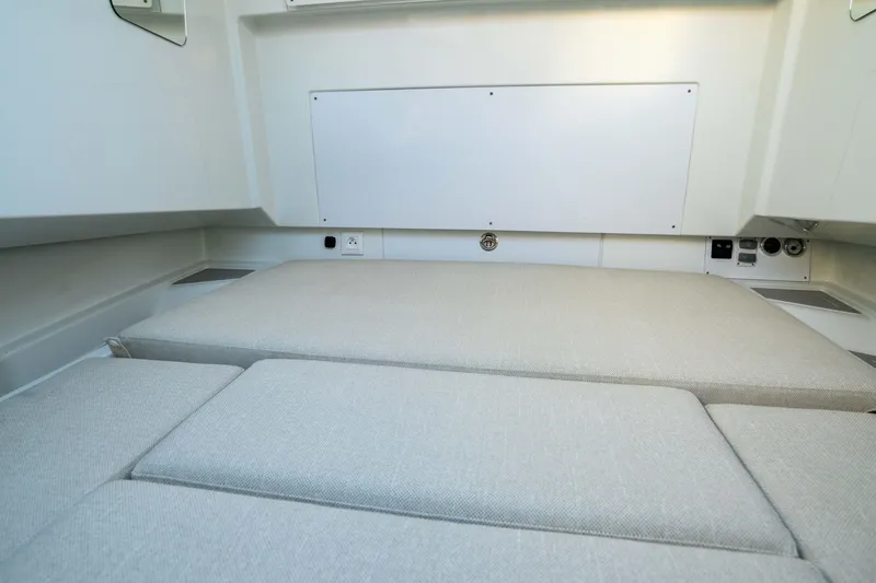 Slide: The Image of Interior cabin of 2026 Wellcraft 28 T-Top boat with cushioned seating. - 17
