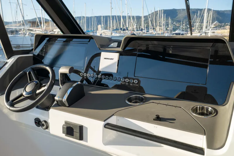 Slide: The Image of Helm of 2026 Wellcraft 28 T-Top boat with modern controls and steering wheel. - 20