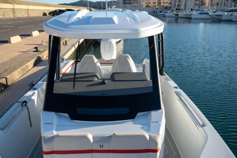 Slide: The Image of 2026 Wellcraft 28 T-Top boat docked in a marina, showcasing sleek design and modern features. - 21