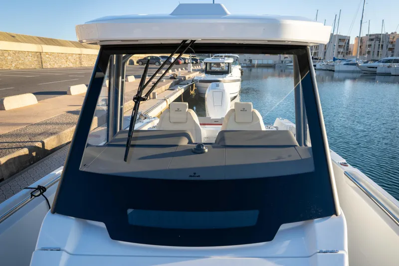 Slide: The Image of 2026 Wellcraft 28 T-Top boat docked in a marina, showcasing sleek design and modern features. - 22