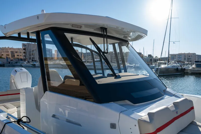 Slide: The Image of 2026 Wellcraft 28 T-Top boat docked in a marina under clear skies. - 23