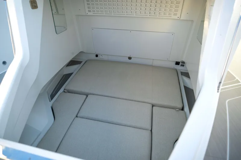 Slide: The Image of Interior cabin of 2026 Wellcraft 28 T-Top boat, featuring cushioned seating and modern design. - 24