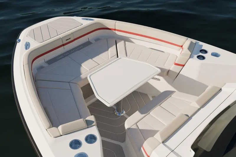 Slide: The Image of 2026 Wellcraft 28 T-Top boat interior with seating and table on calm water. - 25