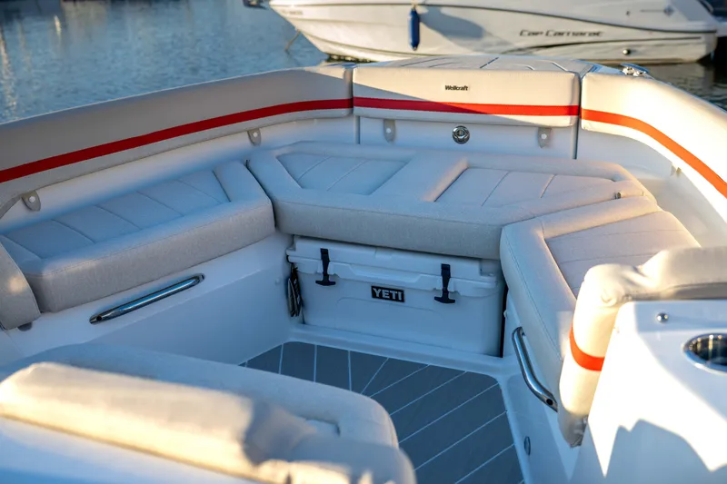 Slide: The Image of 2026 Wellcraft 28 T-Top boat interior with cushioned seating and Yeti cooler. - 27