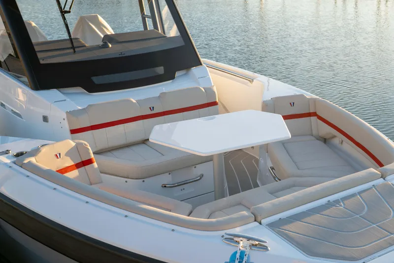 Slide: The Image of 2026 Wellcraft 28 T-Top boat interior with seating and table on calm water. - 28