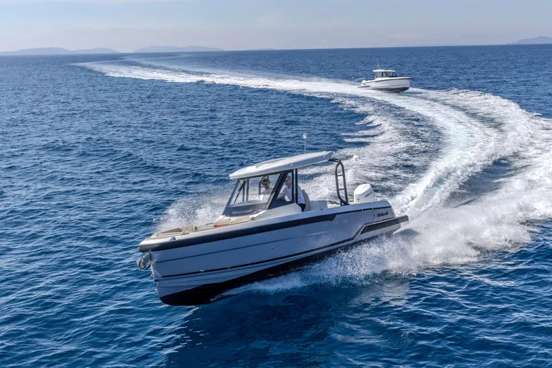 Slide: The Image of 2026 Wellcraft 28 T-Top cruising on open blue ocean waters. - 32