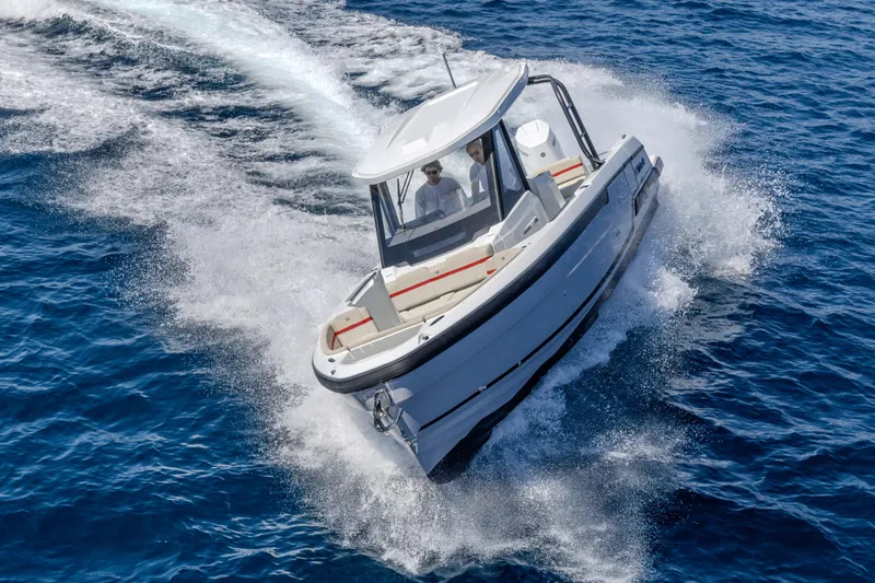 Slide: The Image of 2026 Wellcraft 28 T-Top boat cruising on open blue water. - 34