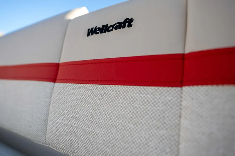 Slide: The Image of 2026 Wellcraft 28 T-Top boat seat with red accent and logo detail. - 9